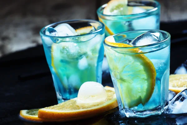 Blue cocktail with blue curacao liqueur and orange