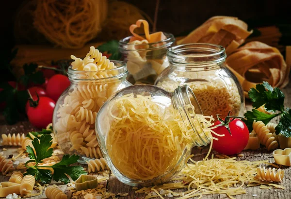 Dry Italian pasta fedelini in a glass jar
