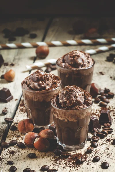 Chocolate-Coffee dessert with whipped cream, nuts and chocolate