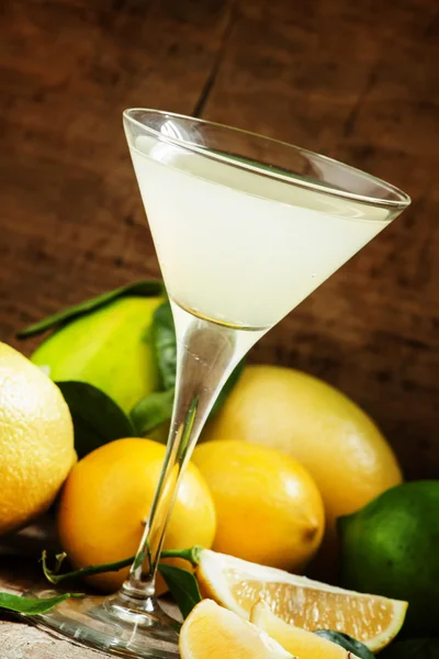 Cocktail with lemon, lime, soda and vodka in a martini glass