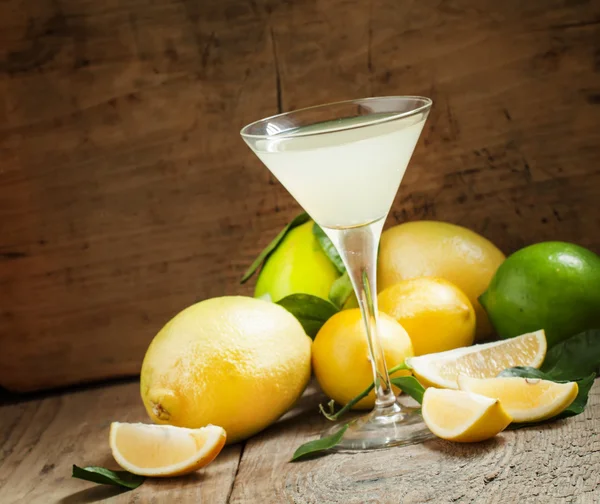 Cocktail with lemon, lime, soda and vodka in a martini glass