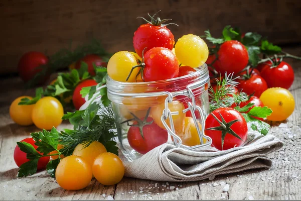 Yellow and red tomatoes in a glass jar