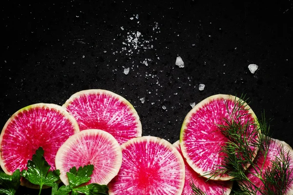 Food background: round slices of watermelon pink radish