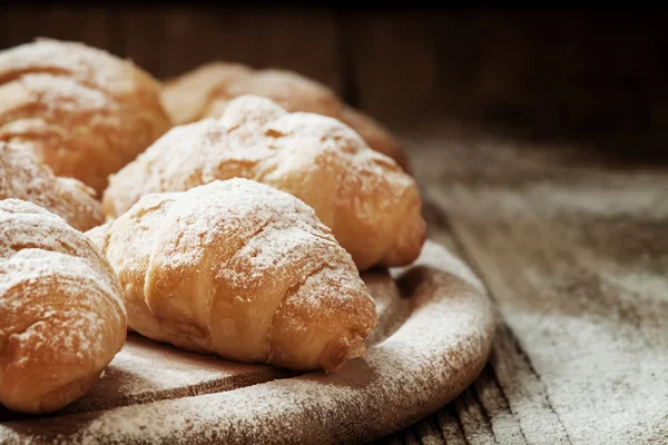 Fresh croissants, sprinkled with powdered sugar