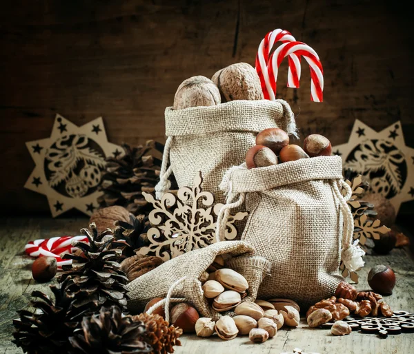 Walnuts, hazelnuts, pistachios in bags made of burlap
