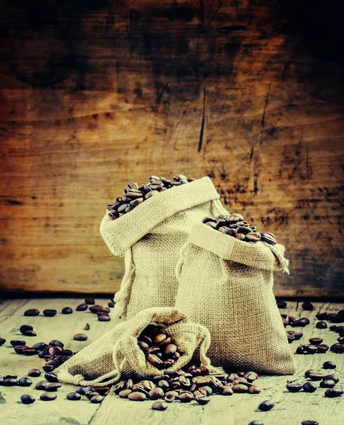 Grains of roasted coffee in bags