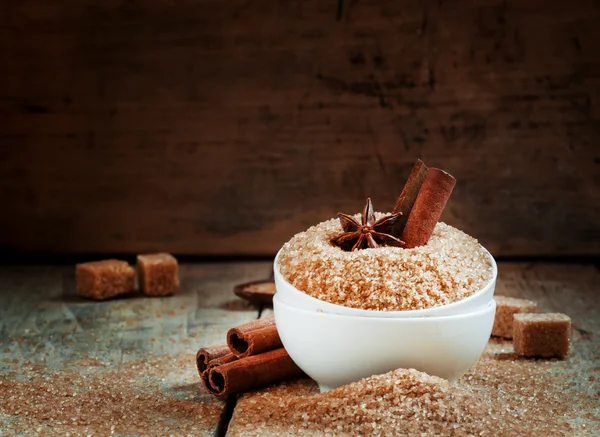 Cinnamon sticks, anise stars in a white mask with brown cane sugar