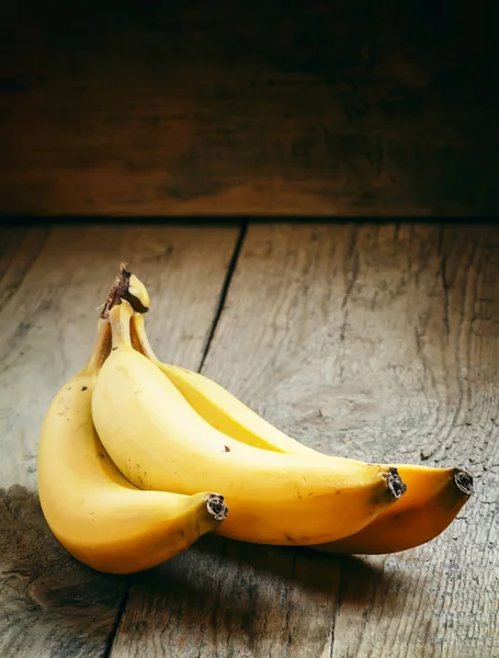 Ripe bananas on an old wooden table in rustic style