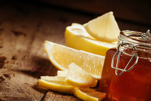 Honey with lemon, herbal medicine and healthy food concept