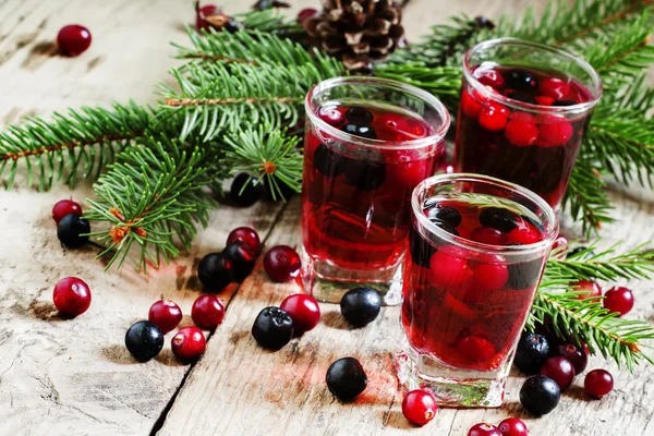 Winter drink with cranberries, cowberries and black chokeberries