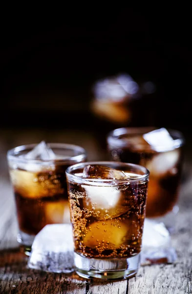 Alcoholic cocktail bourbon cola with whiskey and ice cubes