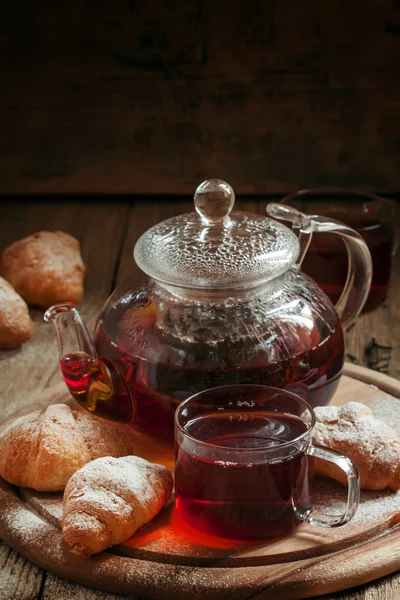 Traditional breakfast with black tea and croissants