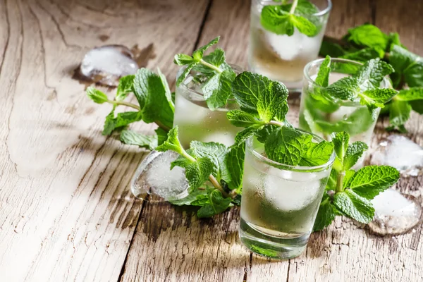 Green mint tea with ice in glasses