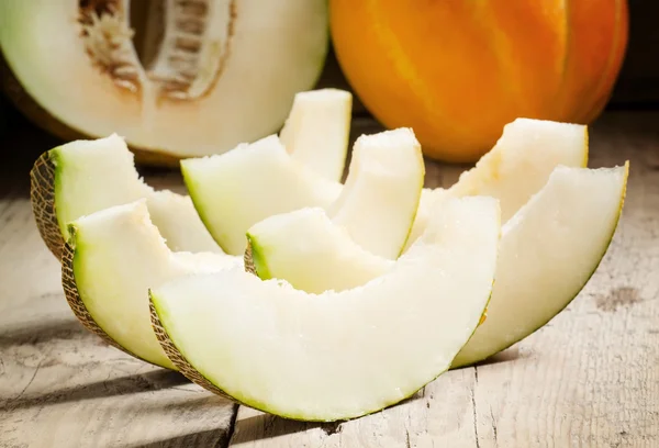 Ripe sliced  melon on a wooden background