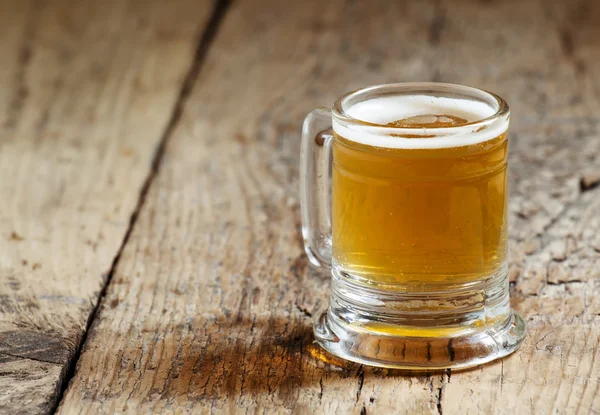Light beer in a little old-fashioned mug