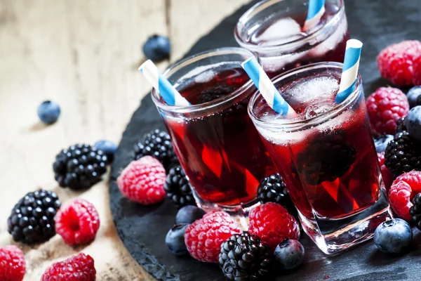 Berry icy cocktail with blueberries, blackberries and raspberries