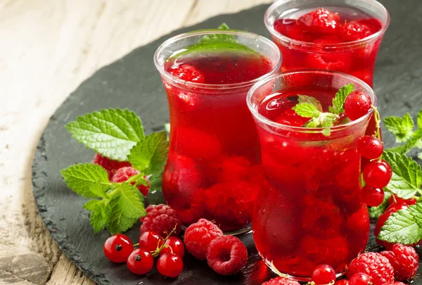 Red drink of raspberry and red currant and mint
