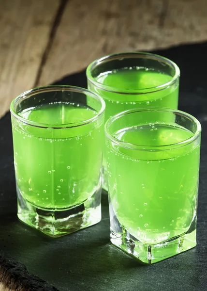 Green cocktail with rum, mint, soda and sugar