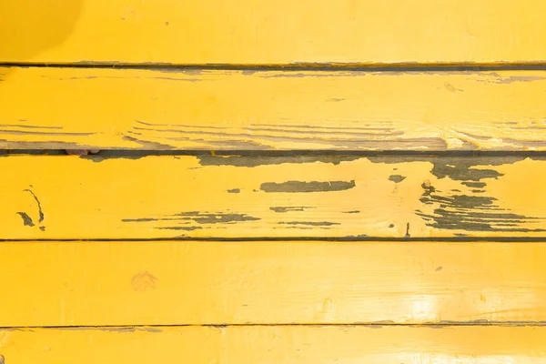 A rustic yellow wood background.