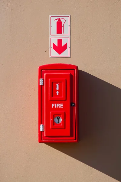 Box with fire extinguisher inside and drop shadow on the wall