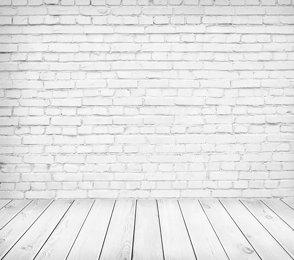 White brick wall and wooden floor. Light room interior