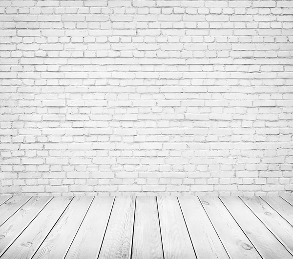 White brick wall and wooden floor. Light room interior