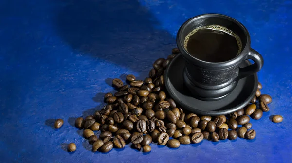 Cup of hot coffee on the old blue background