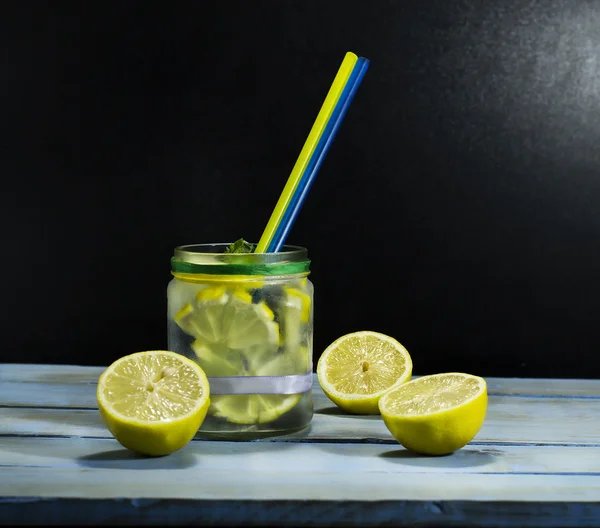 Cold lemonade in bottles with lemons