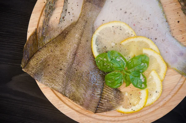 Raw fish sole board lemon basil