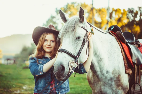 The girl in the hat on the horse