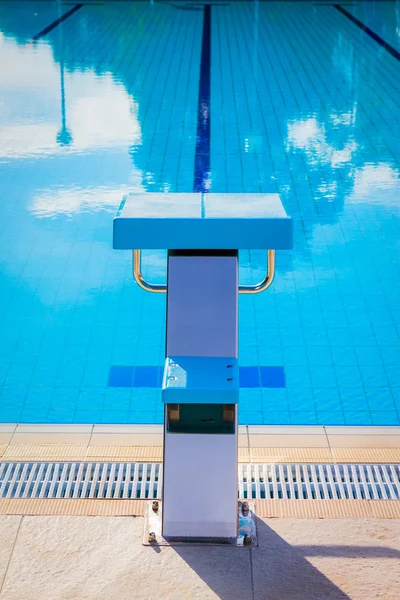 Starting block at the edge of a swimming pool