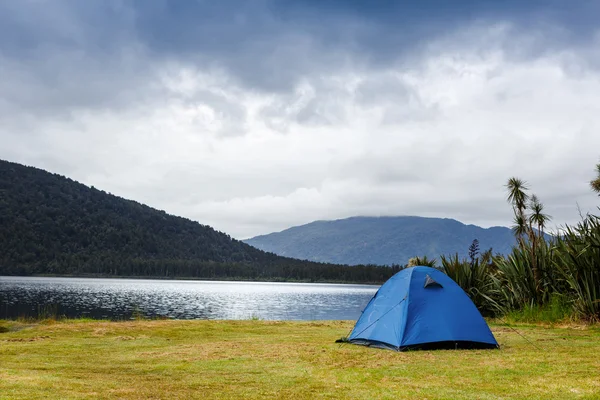 Camping tent over mountain lake