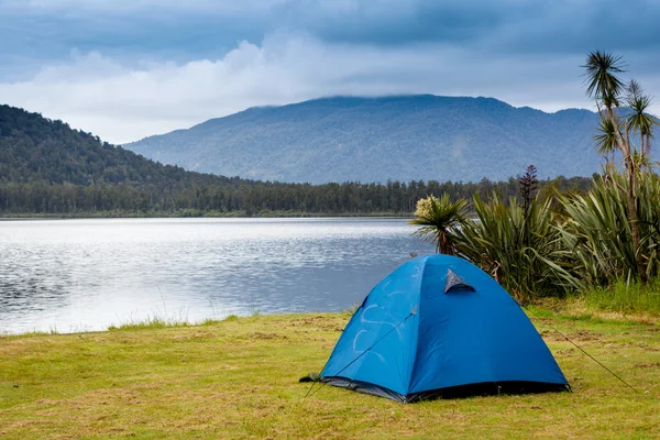 Camping tent over mountain lake