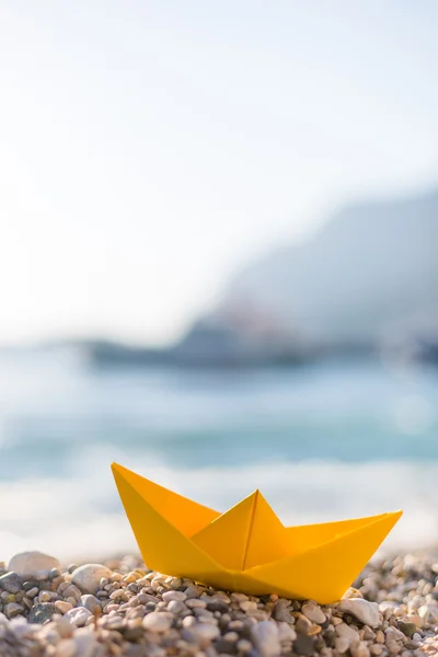 Paper boat on beach