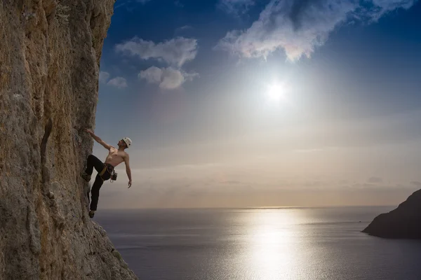 Young man climbing on a wall