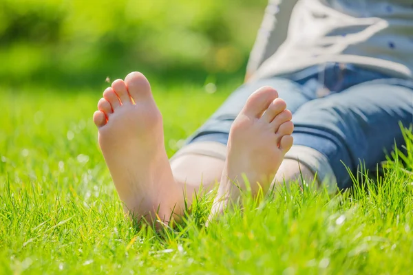 Female bare feet on grass