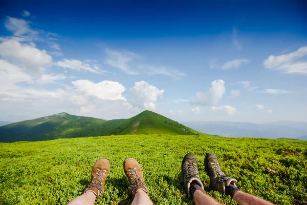 Travel trekking leisure holiday concept. Couple in hiking boots having fun and enjoying wonderful breathtaking mountain view