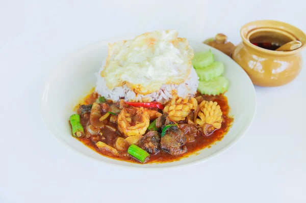 Stir fried seafood in thai red curry paste with rice and fried e