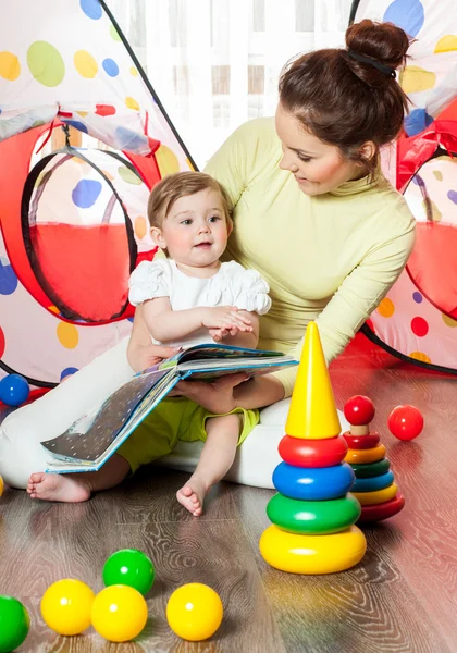 Mother and baby reading together