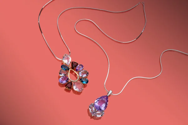 Jewelry gold set of pendants with pink, purple and blue topazes