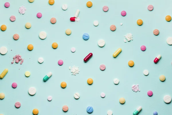 The pretty pills. A photo of different medicinal drugs, tablets and pills on blue background.
