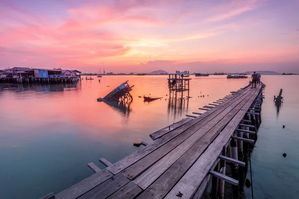 Wooden bridge and a hut sunrise by the shore of George Town, Penang Malaysia