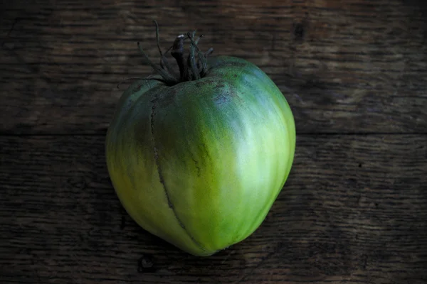 Green beef tomato on a dark wooden table 6