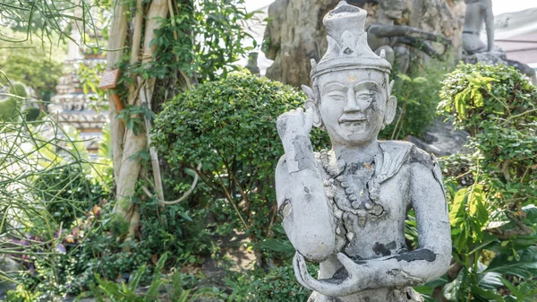 Ancient old man\'s face statue in asian style, Bangkok Thailand