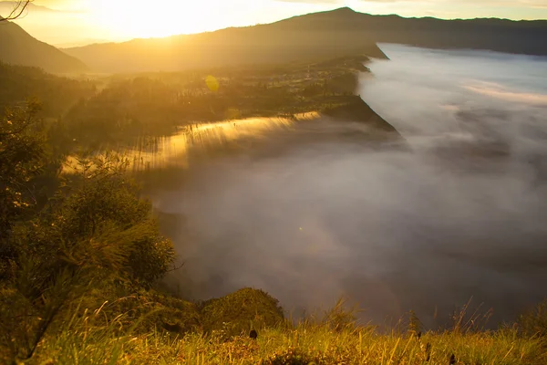 Sunrise Mountains.Asia Nature Morning Volcano Viewpoint.Mountain Trekking,View Landscape Valley Bali Village. Nobody photo. Horizontal picture. The first rays of the rising sun. White Fog.