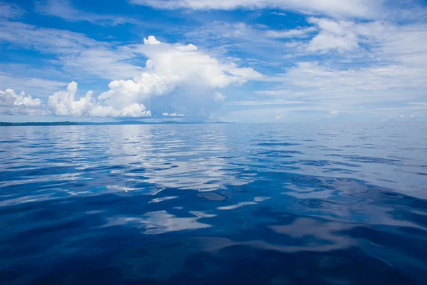 Photo of Blue Sea and Tropical Sky Clouds. Seascape. Sun over Water,Sunset. Horizontal. Nobody Picture. Ocean Background.