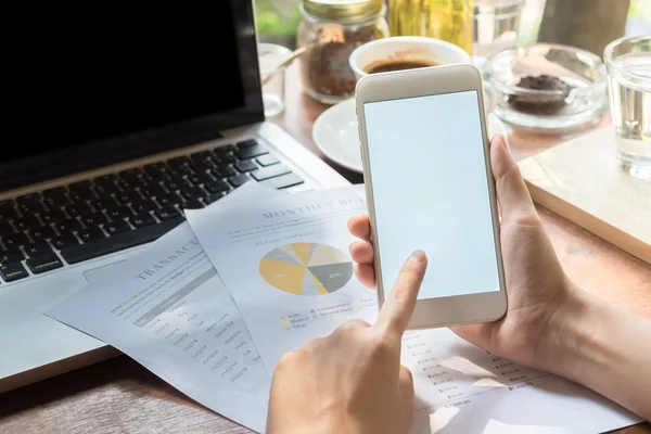 Close up of a woman using smart phone with blank mobile and cup of coffee .Smart phone with blank screen and can be add your texts or others on smart phone.