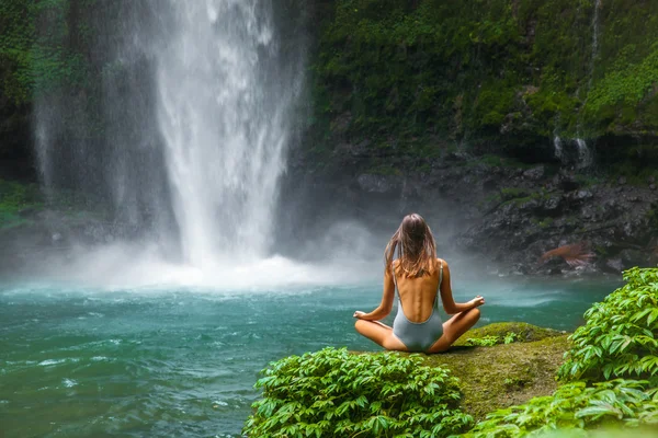Girl Meditating In Front Of Waterfall