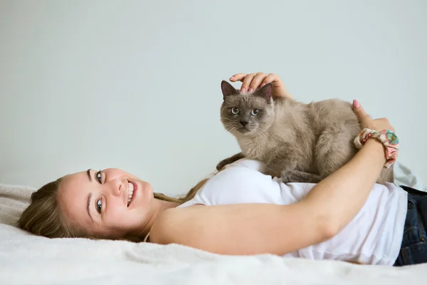 Beautiful young woman with a cat
