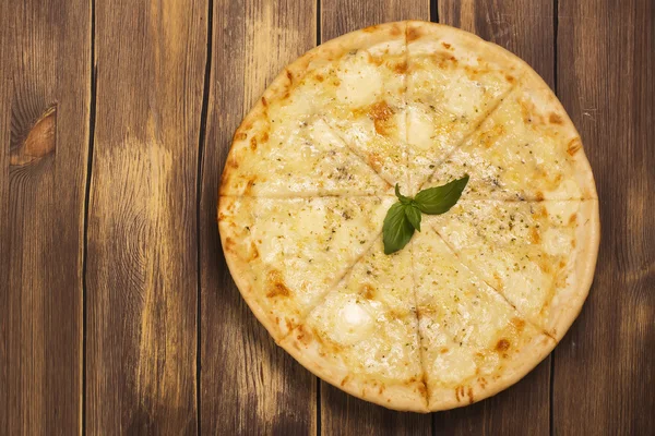 Four cheese pizza with basil and oregano